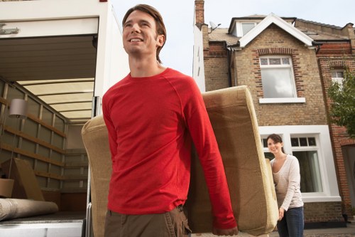 Local movers carrying boxes during a Streatham delivery