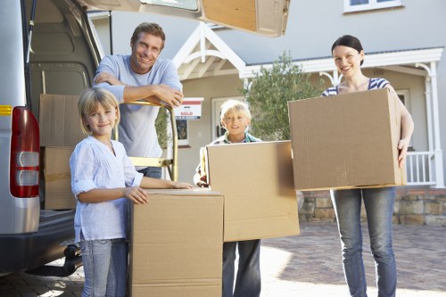 Packed boxes and furniture ready for loading into a van